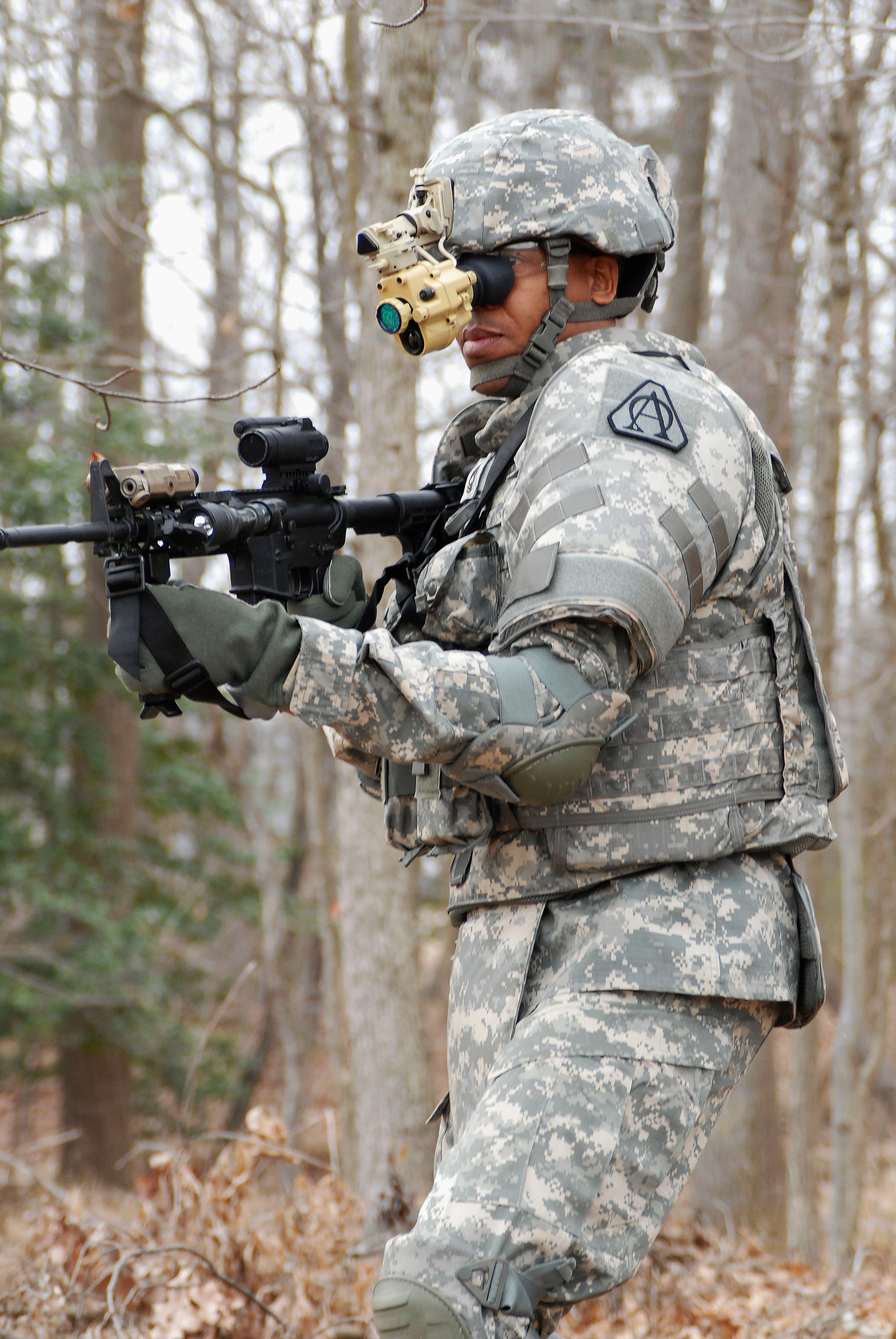US Army soldier using PSQ-20 night vision device in tactical environment